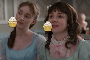 Daphne is on the left eating a cupcake emoji with Eloise on the right eating a cupcake emoji