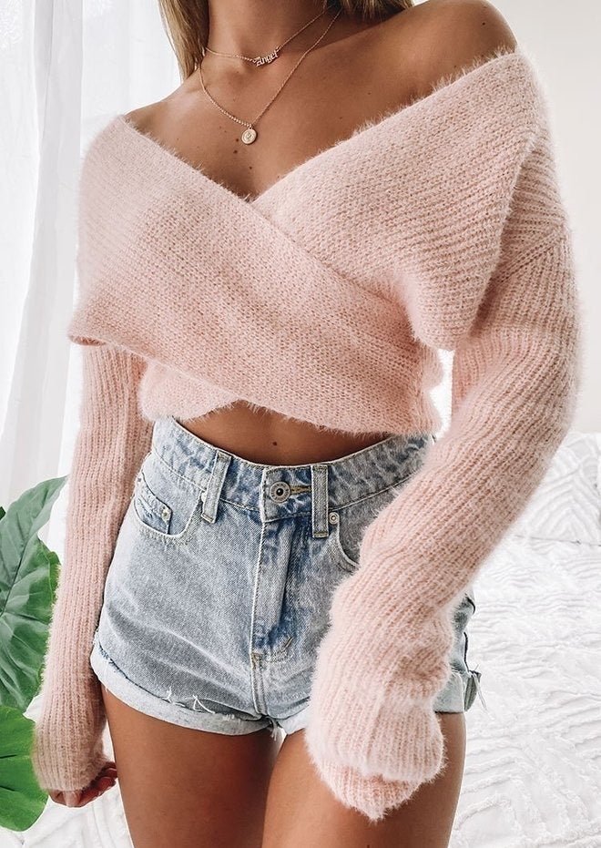 Model wearing pink fluffy criss-cross sweater