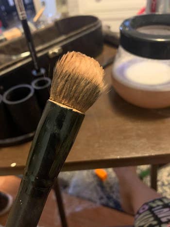 reviewer's before photo of a used makeup brush