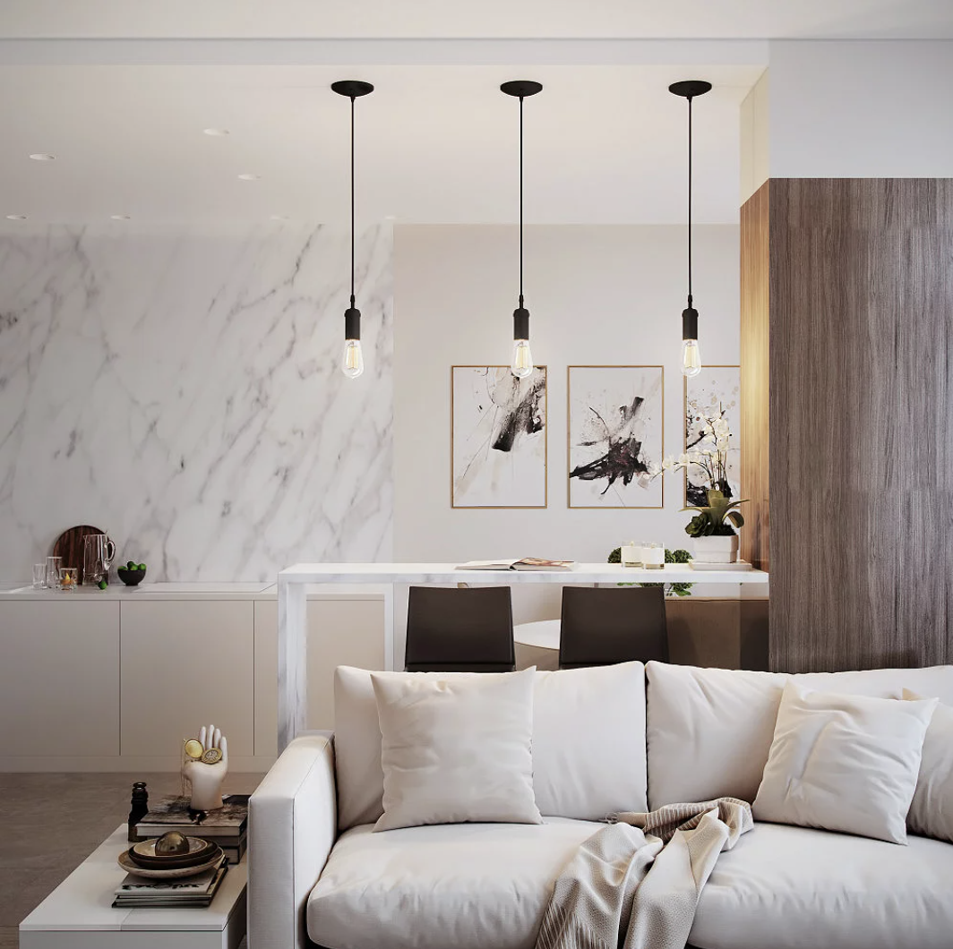 three of the pendant lights hanging over an island