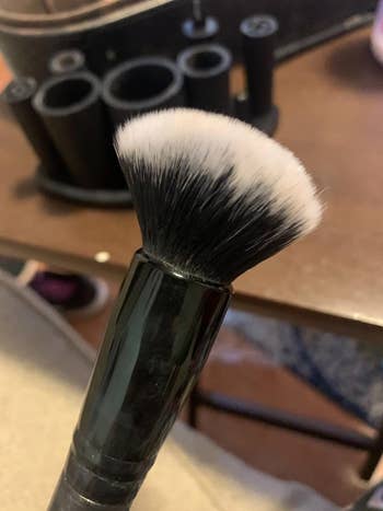 reviewer's after photo which shows the brush completely clean and fluffy again