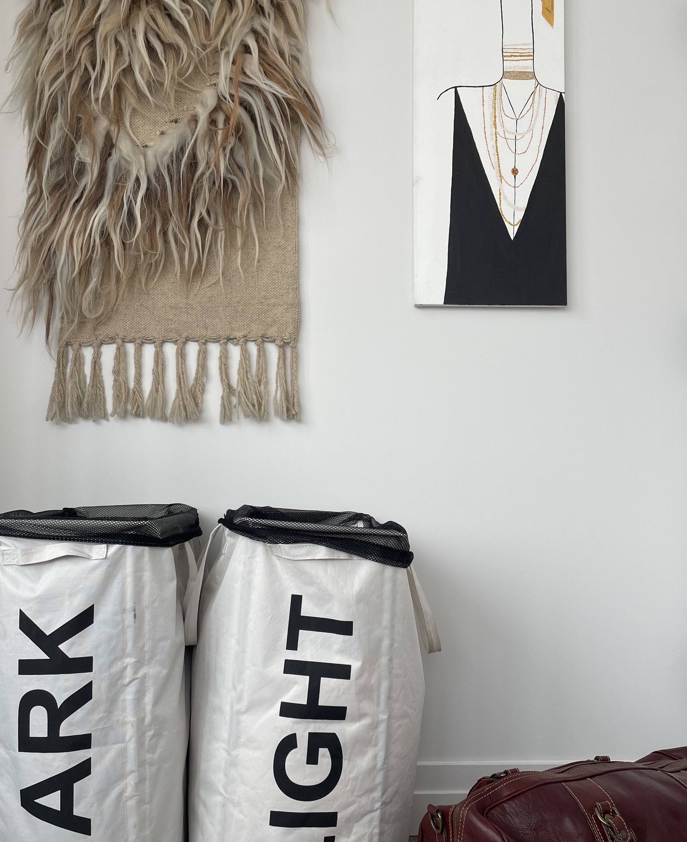 buzzfeed writer&#x27;s two cloth laundry hampers with handles and mesh bags inside, one says &quot;Dark&quot; and the other &quot;Light&quot; 