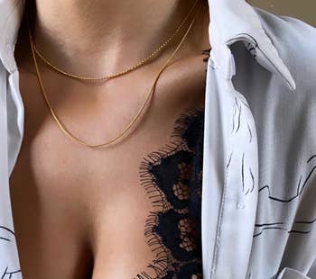 a reviewer wearing two gold necklaces