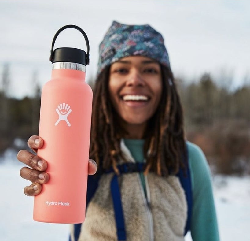 Person is holding a pink Hydroflask bottle