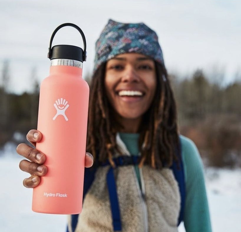 Person is holding a pink Hydroflask bottle