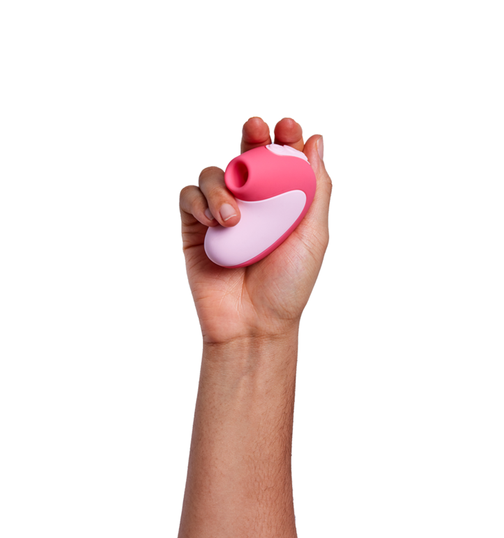 Hand holding the toy in pink