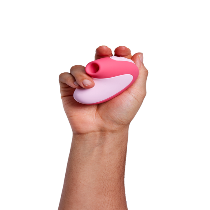Hand holding the toy in pink