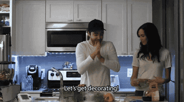 person rubbing hands together and saying let&#x27;s get decorating to another person