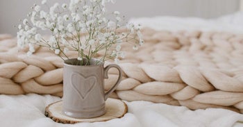 The blanket laid out on a bed