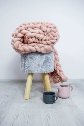 The blanket folded on a stool