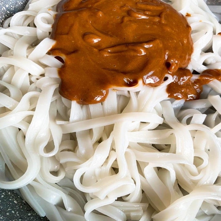 Peanut sauce on top of rice noodles.