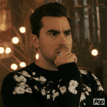 David Rose says, &quot;Oh my god,&quot; dropping his fisted hand from his mouth on Schitt&#x27;s Creek