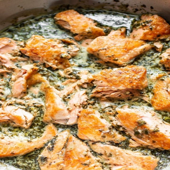 Cooking salmon in a pan.