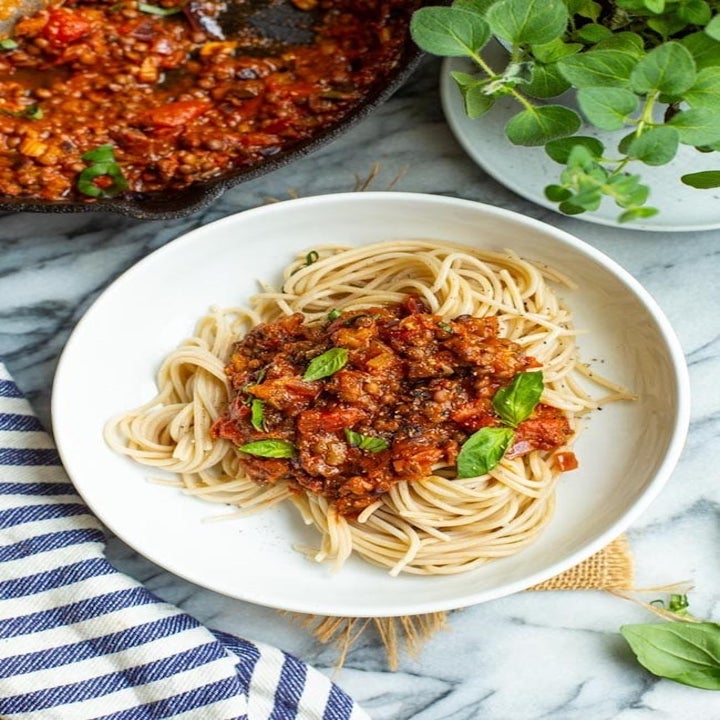 Spaghetti with lentil Bolognese and basil.