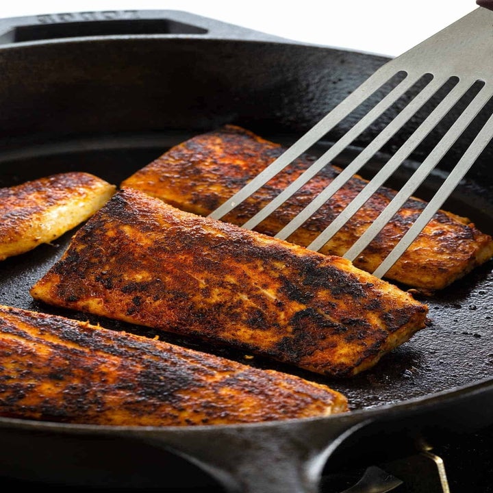 Blackened mahi mahi in a skillet.