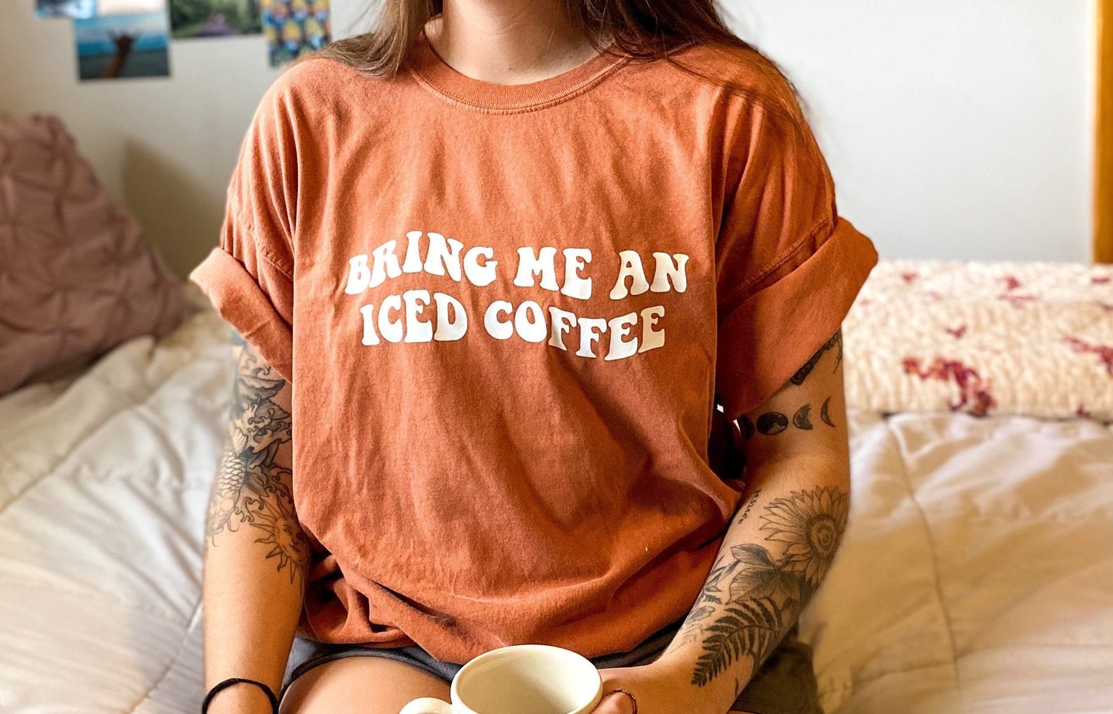 a model wearing the &quot;bring me an iced coffee&quot; shirt in yam