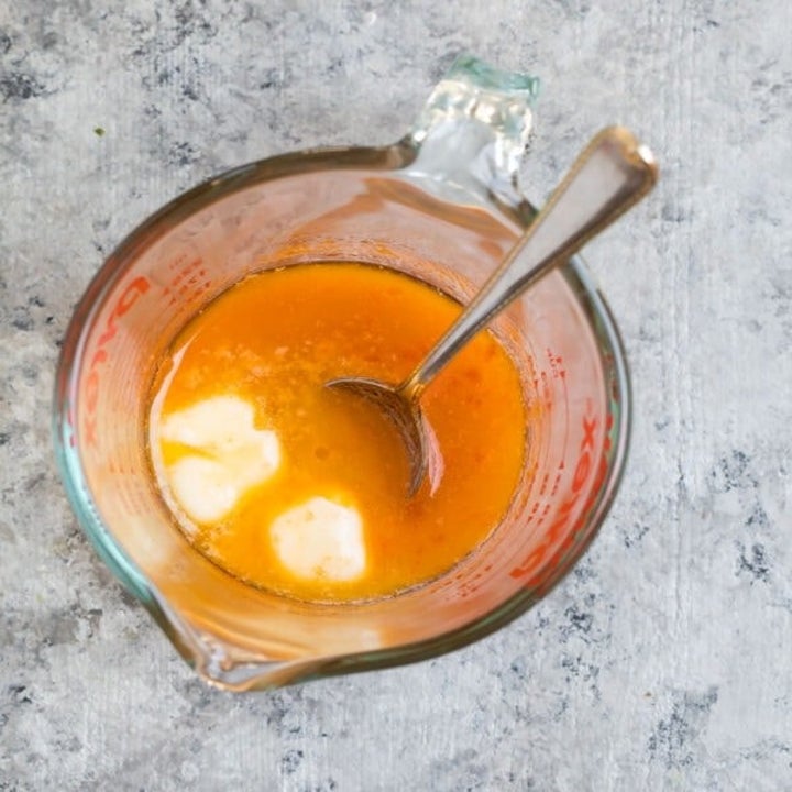 Buffalo sauce in a measuring cup.