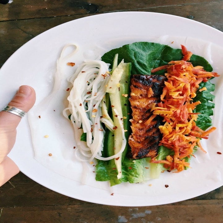 Salmon and veggies in a rice paper roll.