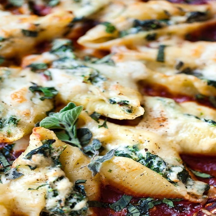 A close-up of spinach and ricotta stuffed shells.