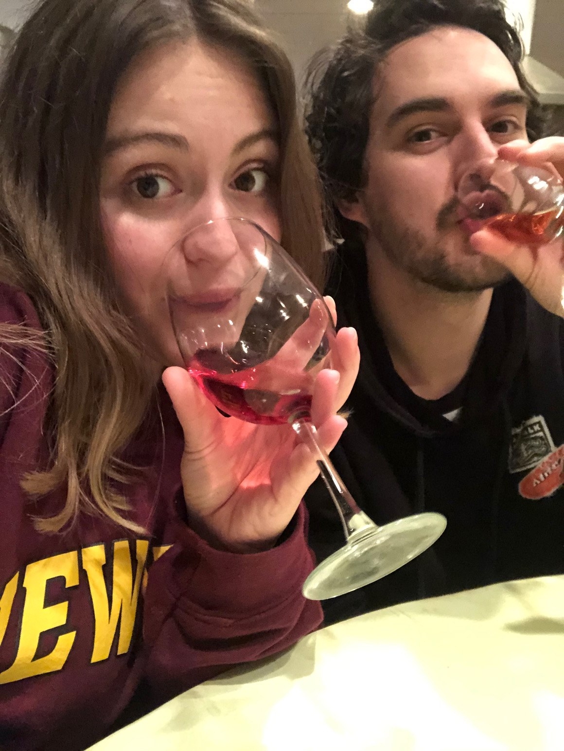 Woman and man sipping wine