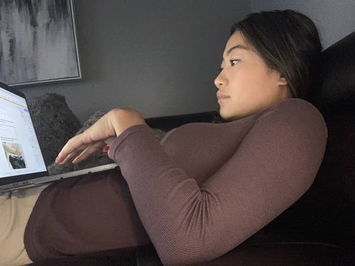 May lying down while on her computer to show her bad posture