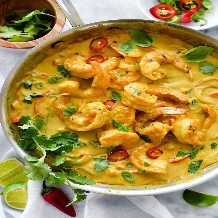A big pot of shrimp curry with vegetables.