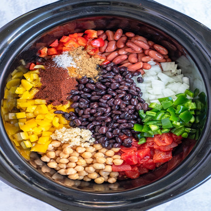 Beans, corn, and vegetables in a slow cooker for chili.