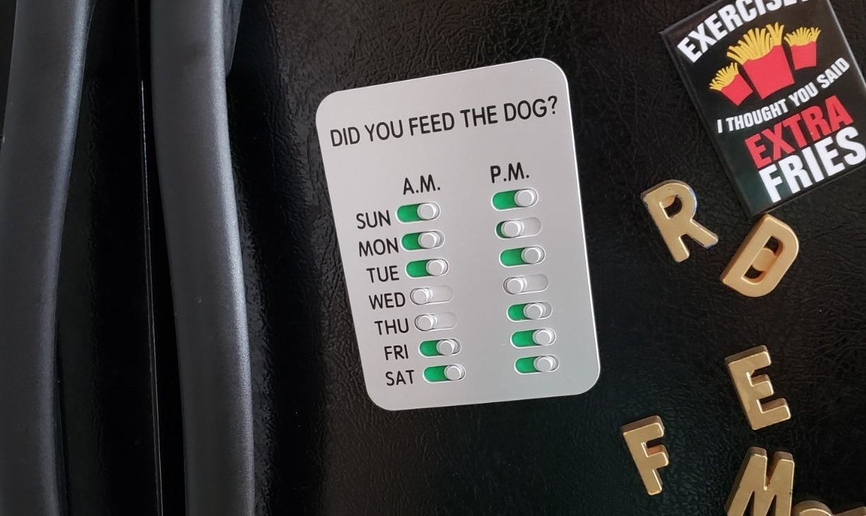 The dog feeding tracker attached to a refrigerator 