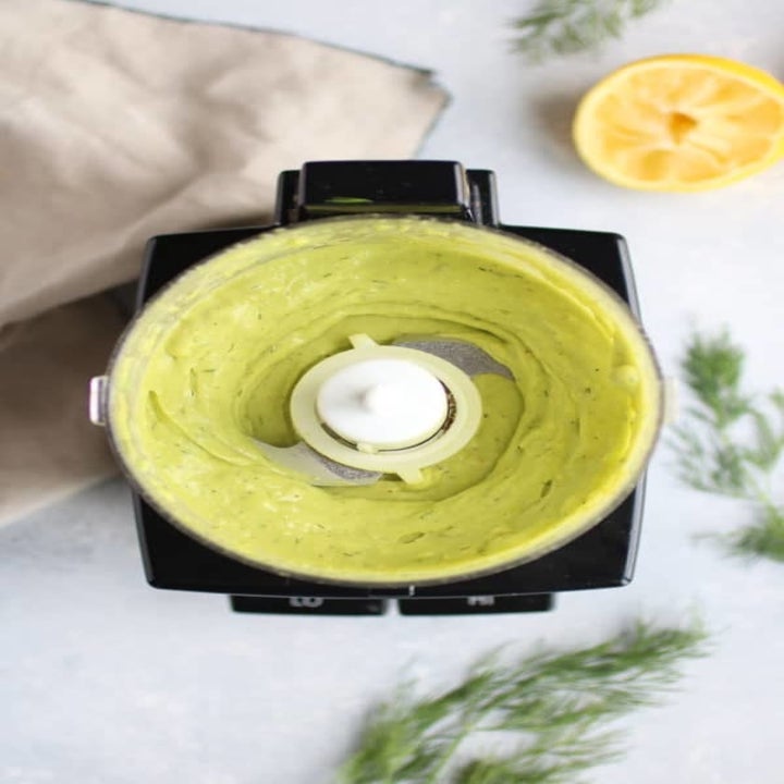 Making avocado sauce in a food processor.