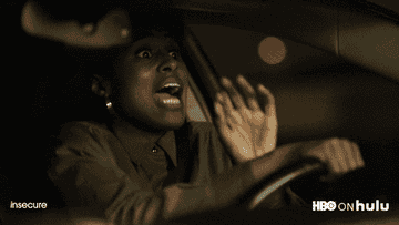 Issa Rae screams as she drives a car on Insecure