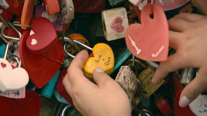 Lara Jean holding onto a lock that says &quot;Eve plus Dan&quot;