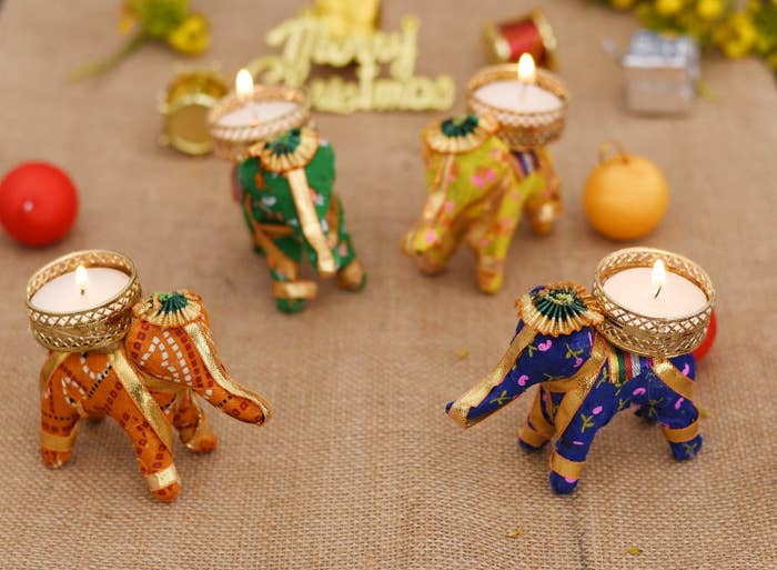 A set of 4 cotton elephants with tealights in them