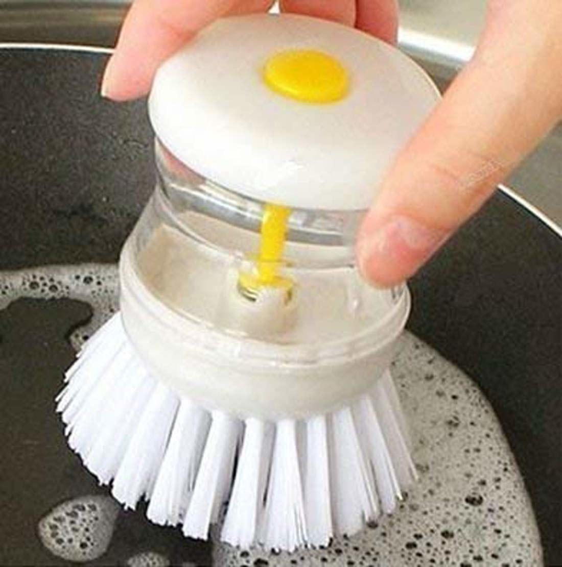 Brush with dispenser on top. Press button on dispenser to release soap.