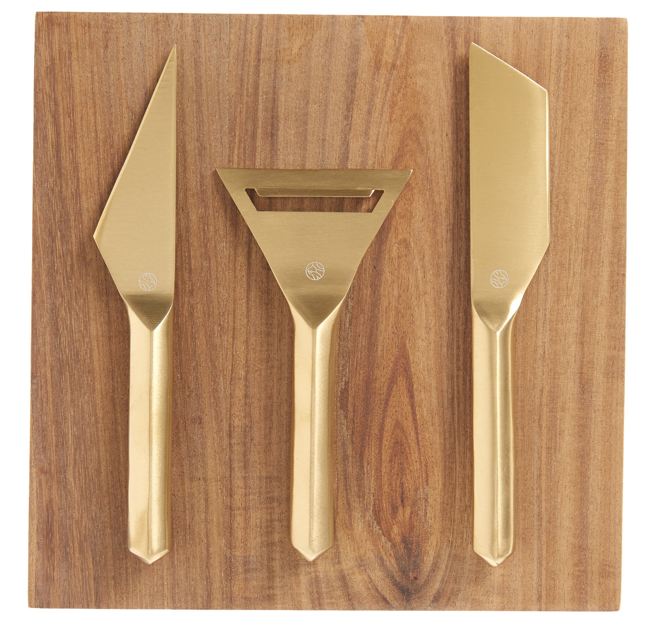 wooden cheese board with three gold serving utensils