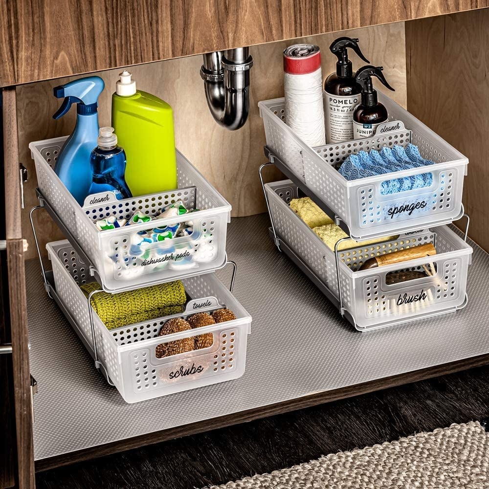 the baskets added under a sink to organize tons of cleaning supplies