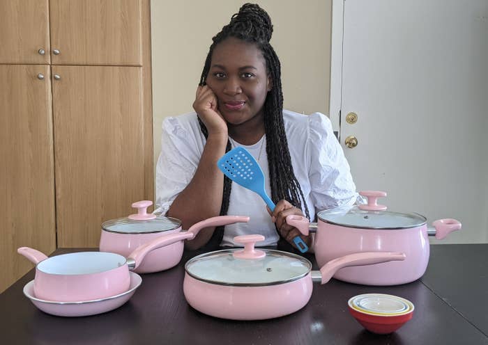 Kaysey sitting with her set of pink Tasty cookware