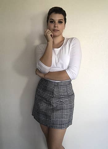 reviewer wearing plaid skirt 