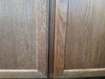 Reviewer photo of wood cabinet before using cleaner