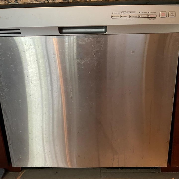 Reviewer photo of dishwasher before using stainless steel wipes