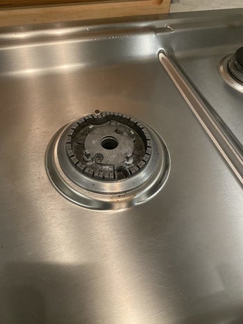 Reviewer photo of clean gas range burner after using cleaner