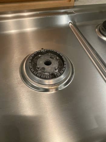 Reviewer's clean gas range burner after using cleaner