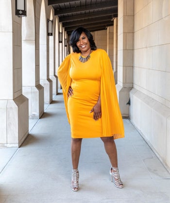 reviewer wearing the dress in orange