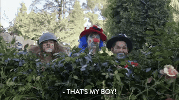 Three of the Workaholics say, &quot;That&#x27;s my boy,&quot; while watching from behind a bush, dressed in clown costumes, on Workaholics
