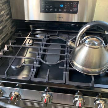 Reviewer showing the liners on their stove top