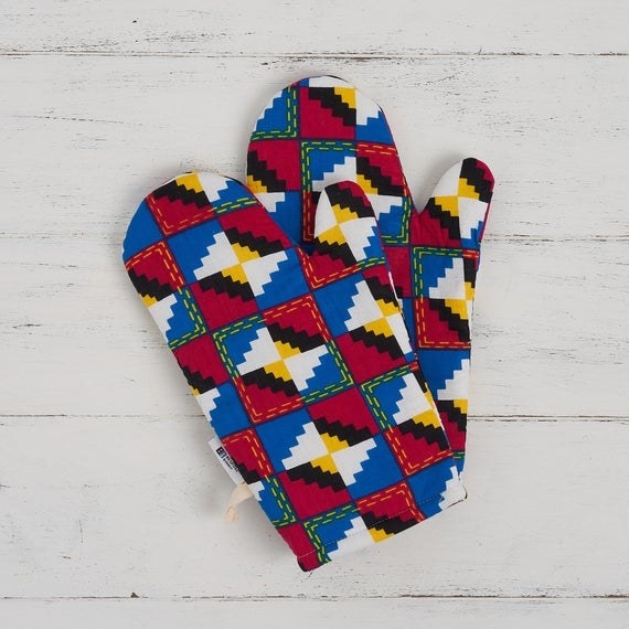 red, white, blue, and black-patterned oven mitts