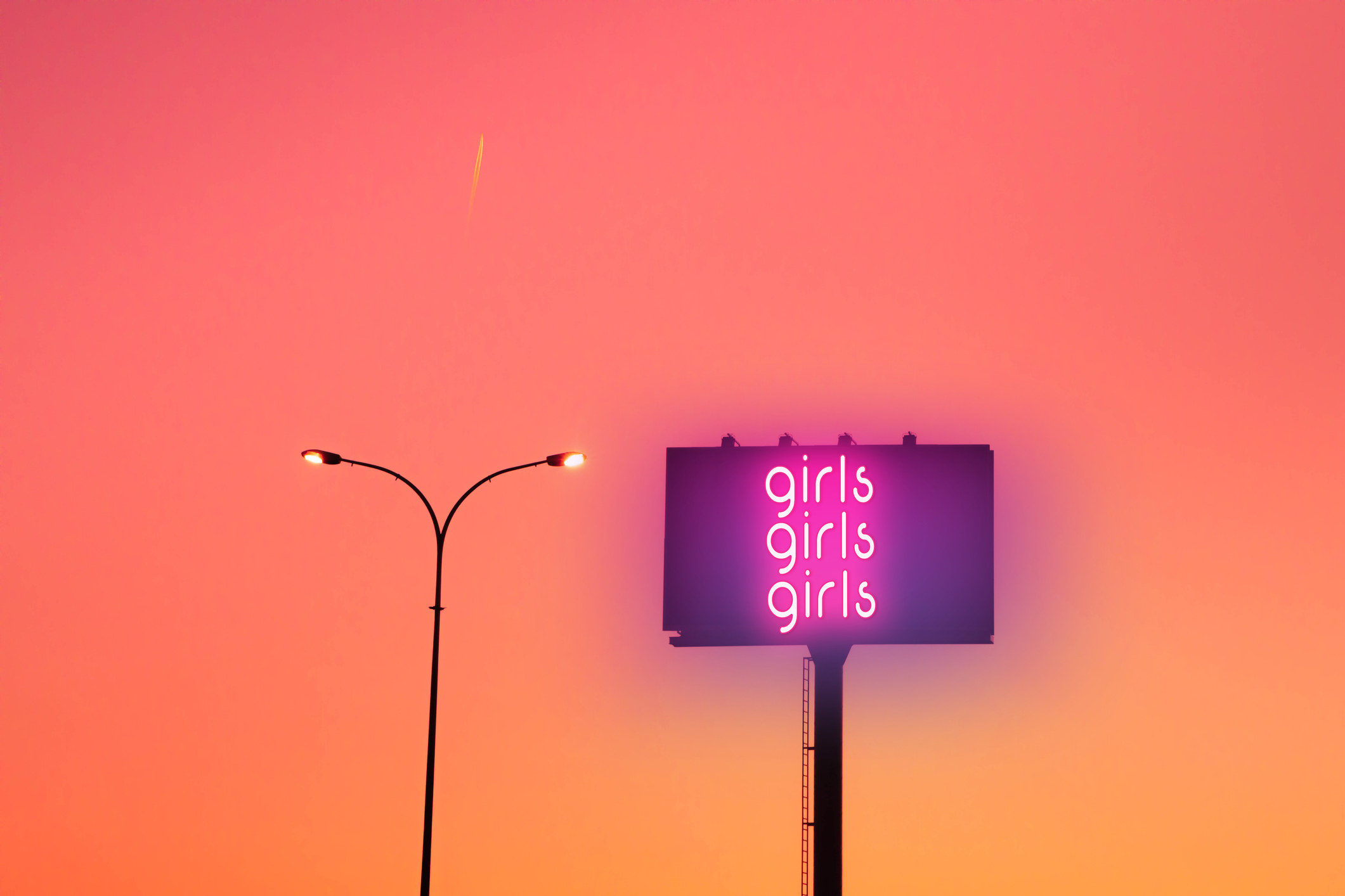 An image of a TV screen that says &quot;girls, girls, girls&quot; in fluorescent lighting 