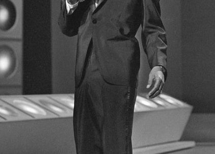 man with thick mustache singing