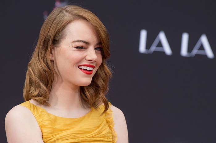 Emma Stone winking and smiling at &quot;Ryan Gosling and Emma Stone hand and footprint ceremony&#x27;&quot; at  the TCL Chinese Theatre IMAX in December 2016 