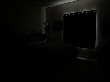 Same reviewer showing a blacked out room with the curtains drawn