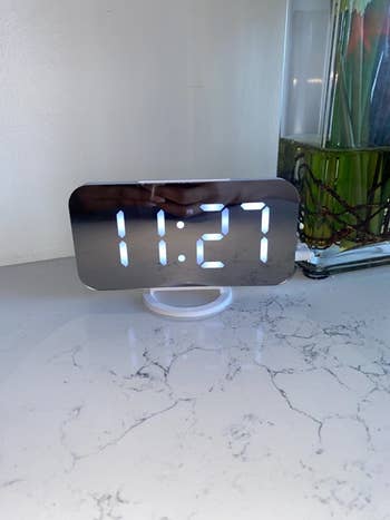 Reviewer alarm clock on marble table